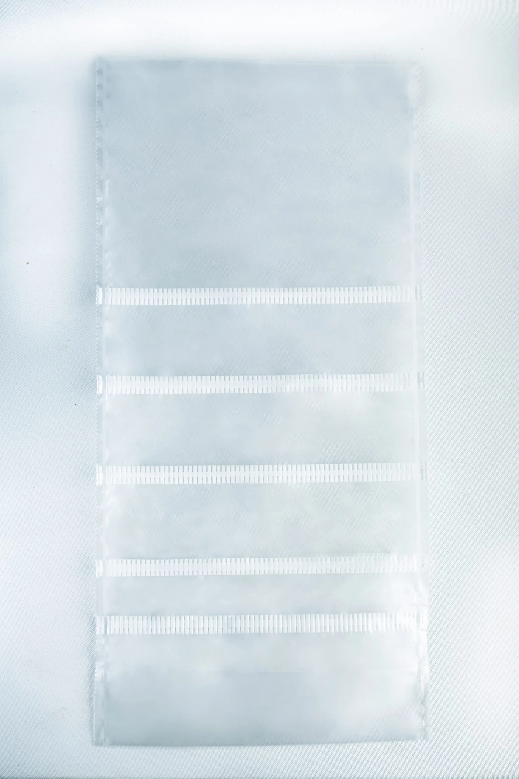 A transparent plastic sheet with six horizontal pockets, ideal for organizing Mushroom Grow Bags Unicorn for spawn and substrate or other mushroom grow bag supplies, shown on a white background.