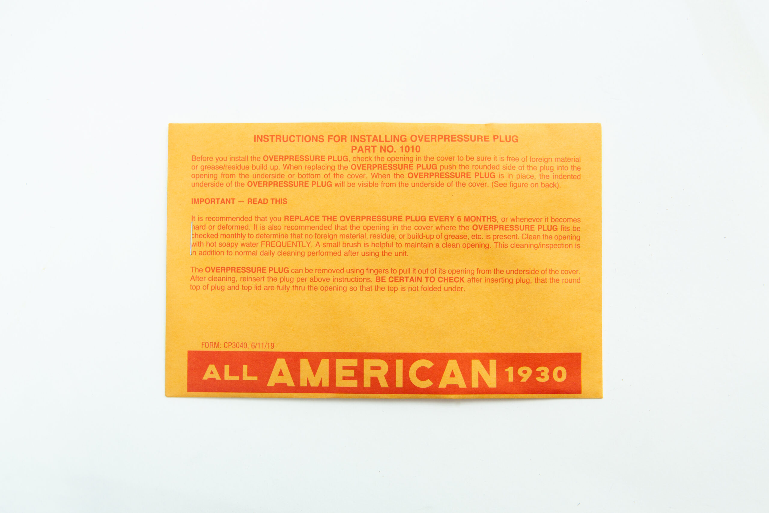 Orange instruction card for installing the All American rubber overpressure plug for sterilizer (Part 1010), featuring bold "ALL AMERICAN 1930" text at the bottom.