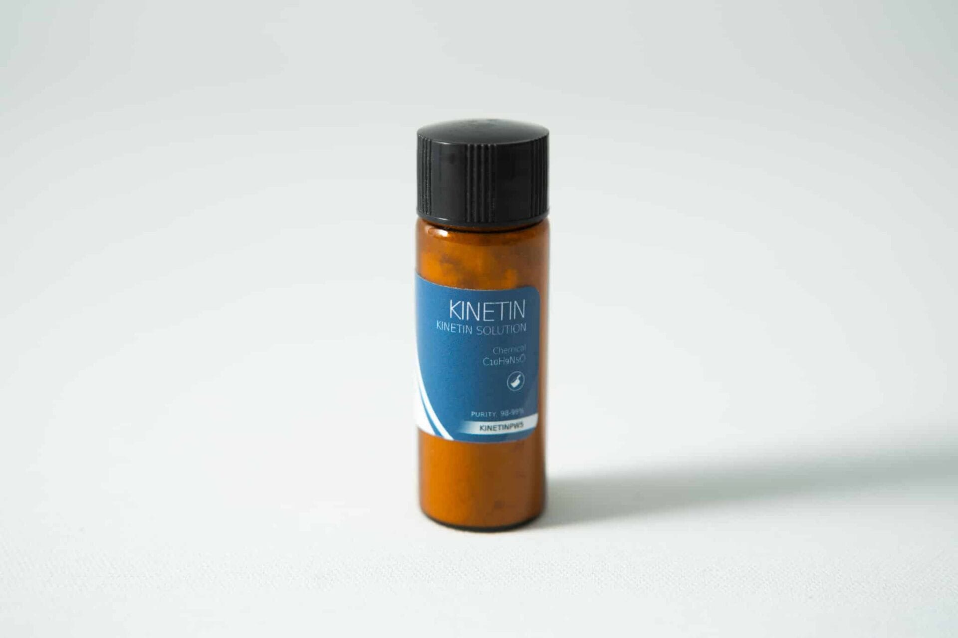 A brown bottle with a black cap labeled Plant Cell Kinetin Powder, ideal for plant cell research, on a plain white background.