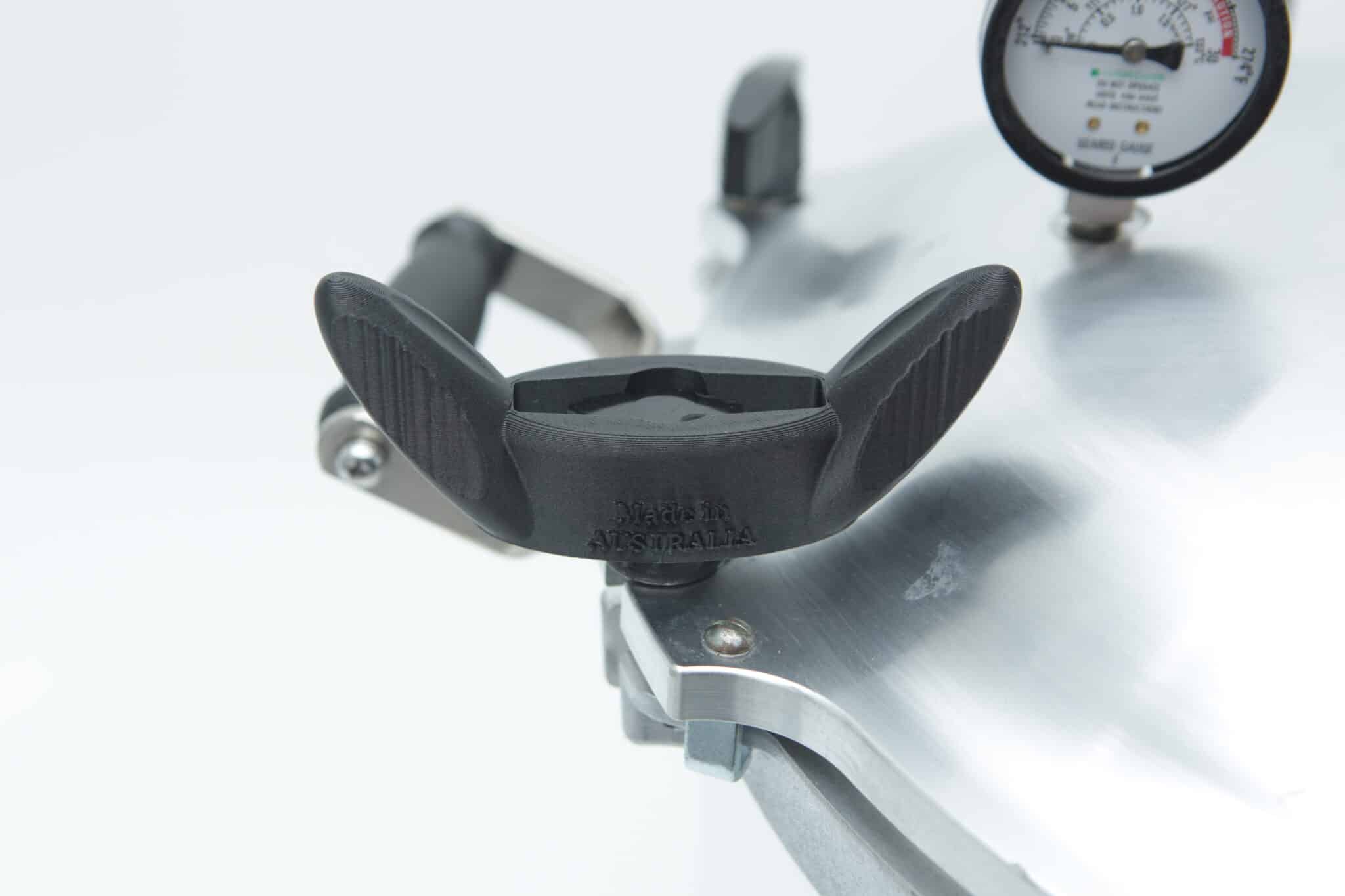 Close-up of a Wingnut Wrench for All American Steriliser by Rootlab Original (3D printed), shown near the steriliser lid with black handle and pressure gauge.
