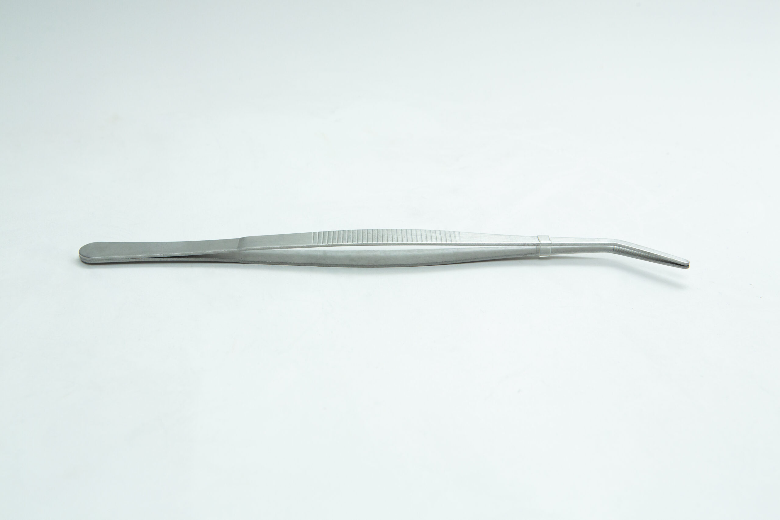 A silver metal tweezers with a slightly curved tip on a plain white background.