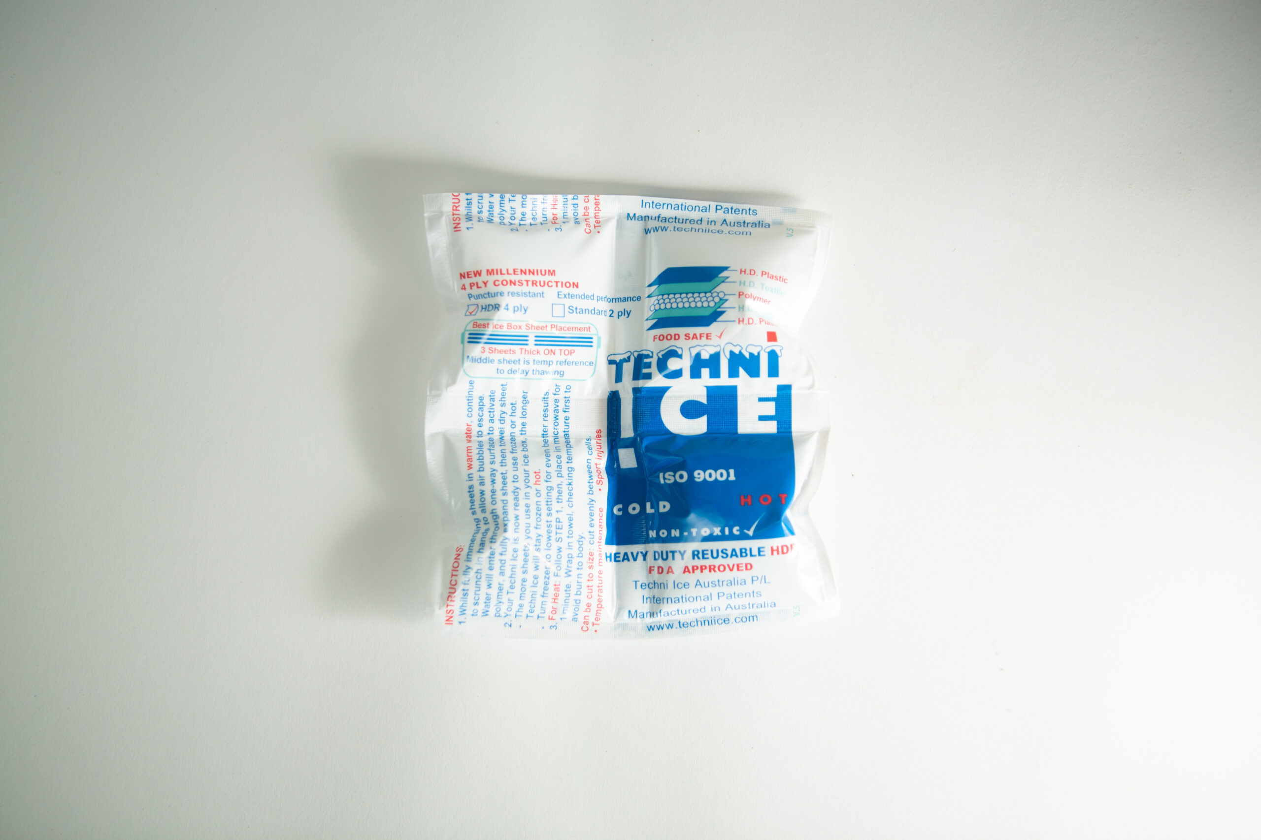 A sealed Technic Ice cold/hot reusable pack sits on a white surface.