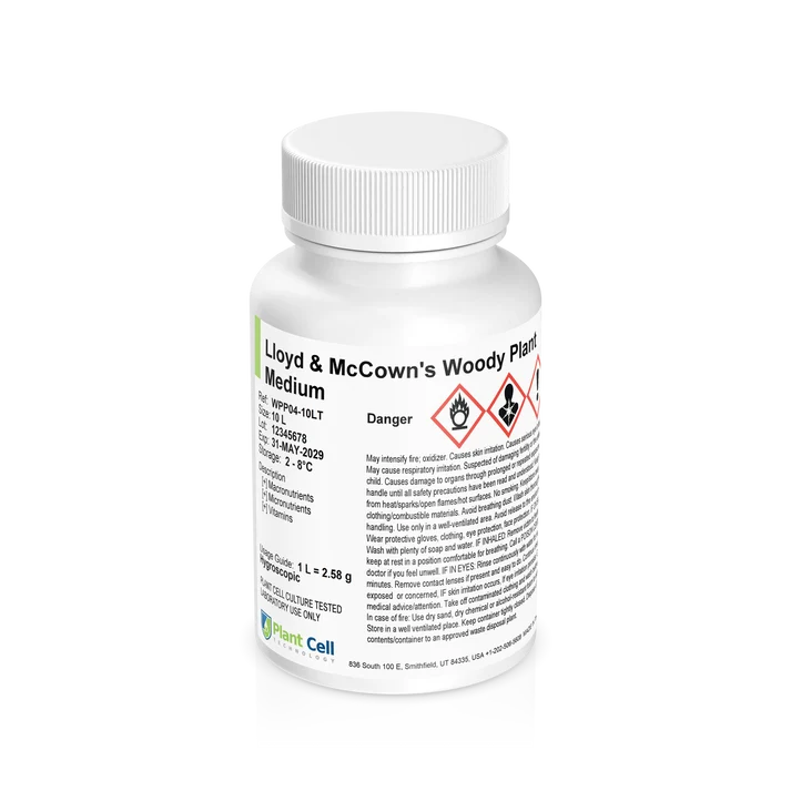 White bottle labeled Lloyd & McCowns Woody Plant Medium with hazard symbols and text warnings.
