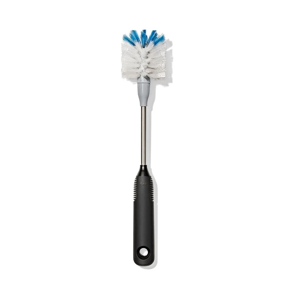 Bottle brush with a black handle and white bristles, tipped with blue, on a white background.