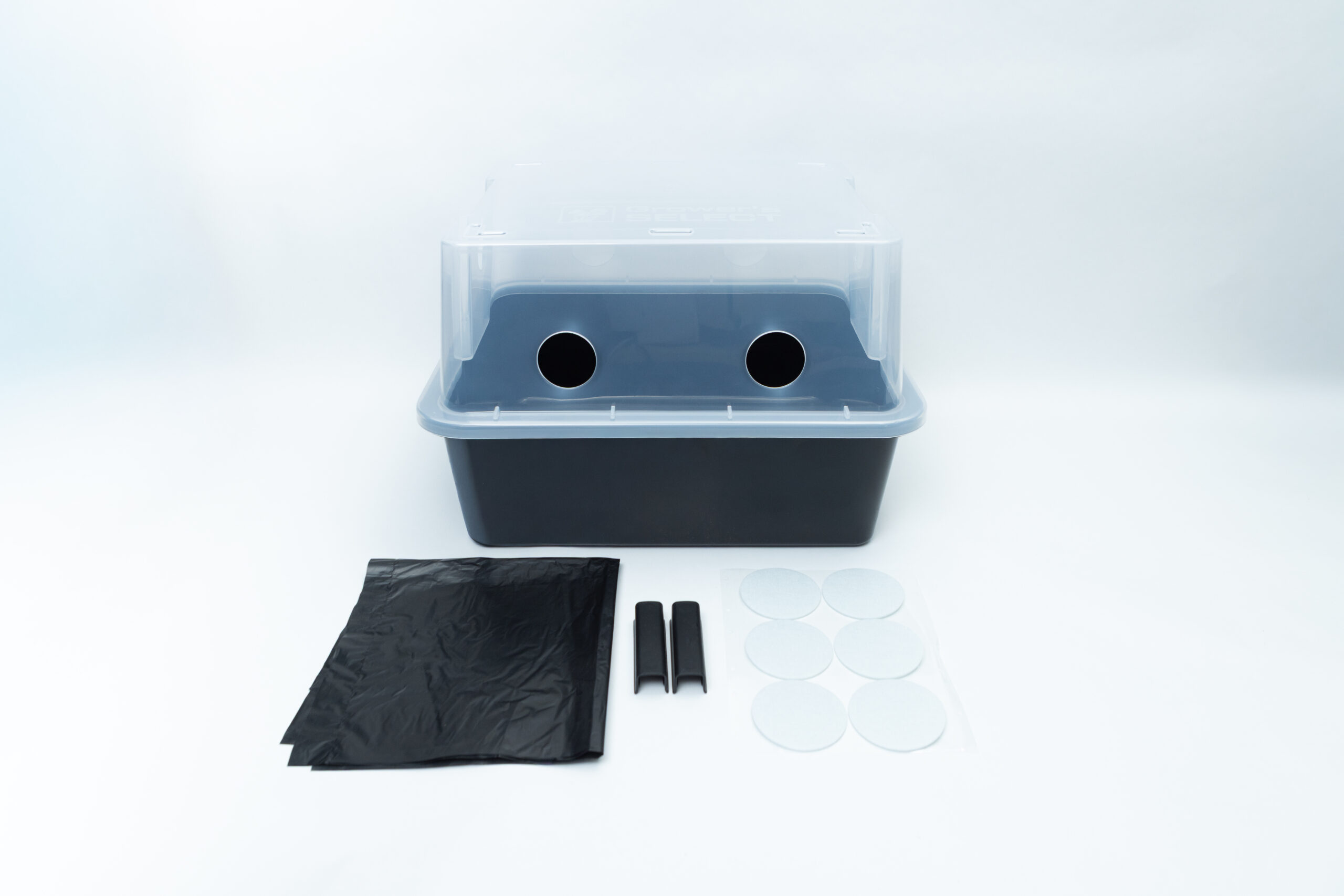 A plastic mushroom grow box with a lid, including a plastic bag, two clips, and six adhesive filters.